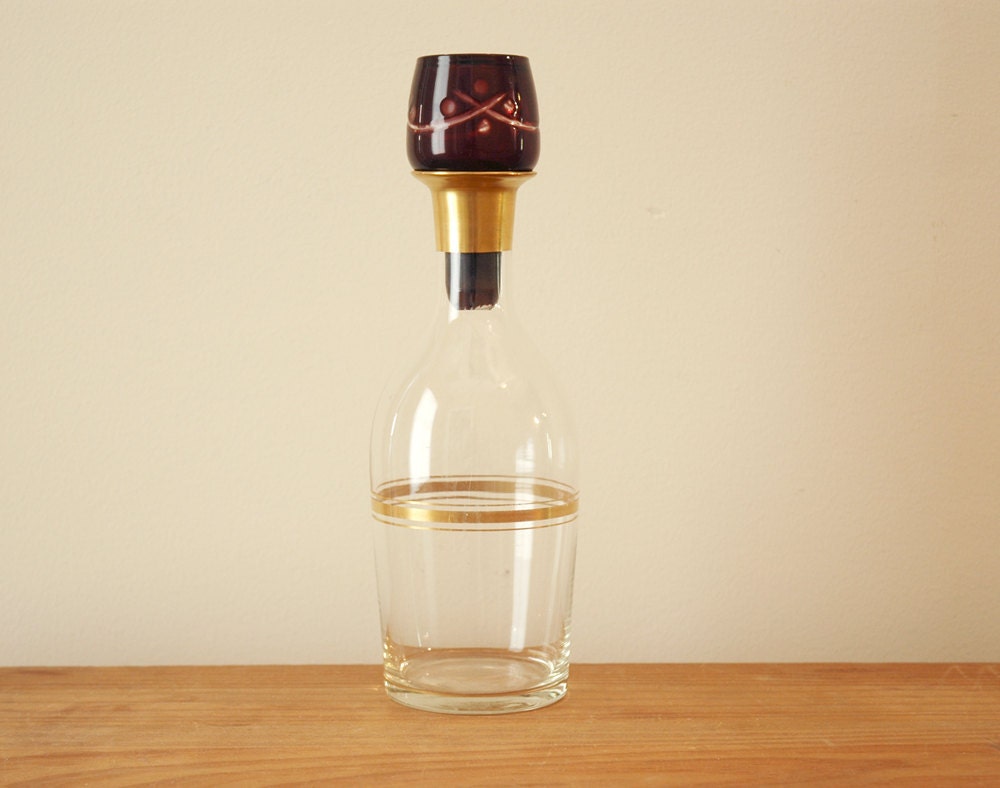 Vintage Bar Liquor Decanter Clear Glass Bottle with Gold Accents and Dark Red Glass Stopper