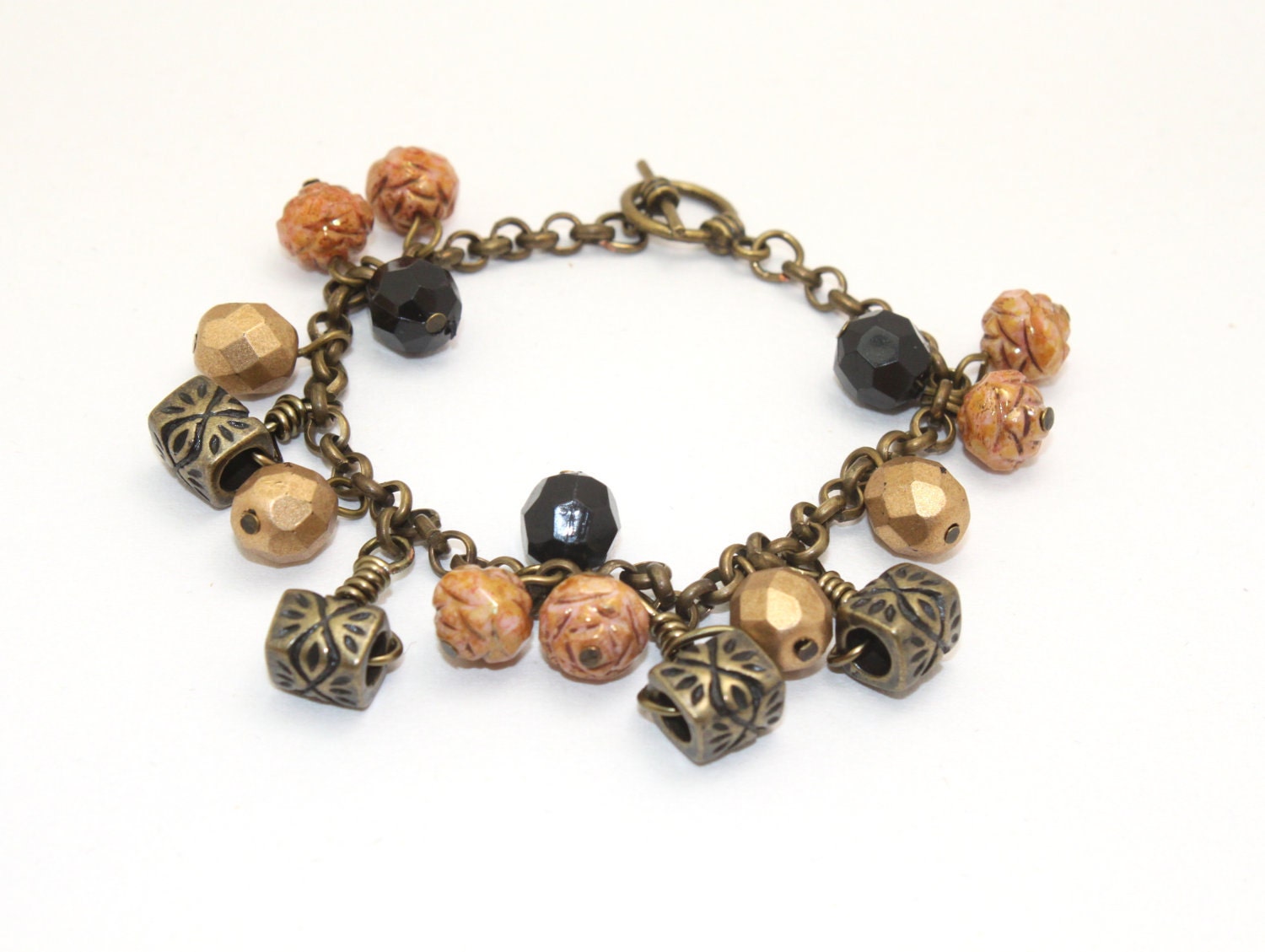 Charm bracelet with antique brass chain, antique brass charm and faceted beads
