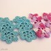 Set of 12 crochet flower appliques. 6 purple melange motifs and 6 pale blue motifs.