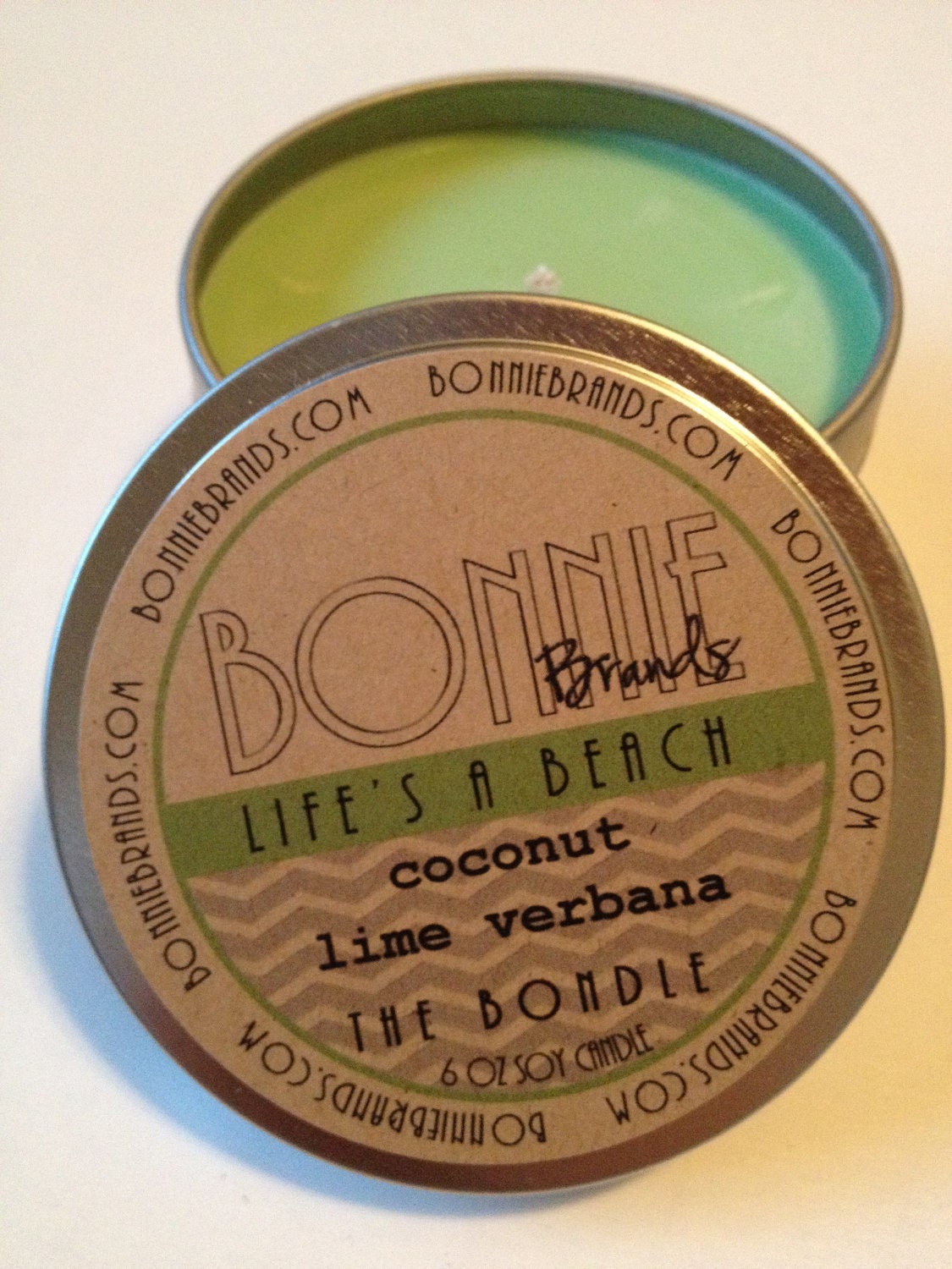 The Bondle: 6 oz Life's A Beach Soy Candle flavored with Coconut Lime Verbana in a Seamless Travel Tin