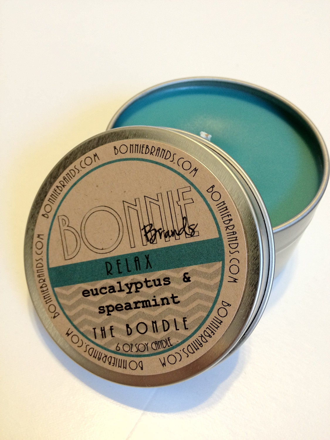The Bondle: 6 oz Relax Soy Candle flavored with Eucalyptus & Spearmint in a Seamless Travel Tin