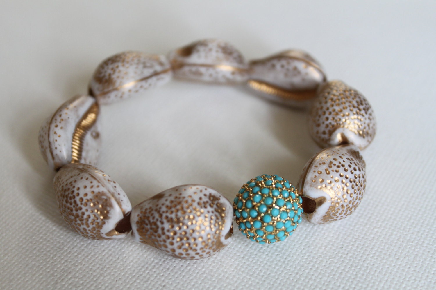 Caicos bracelet - Modern, elegant & preppy.  Vintage resin shell beads grounded with a turquoise, gold plated crystal pave bead