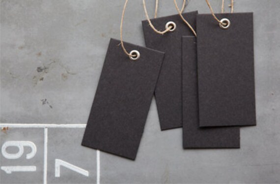 all black card board tag with a matt iron/metal eyelet and hemp string