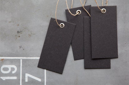 all black card board tag with a matt iron/metal eyelet and hemp string