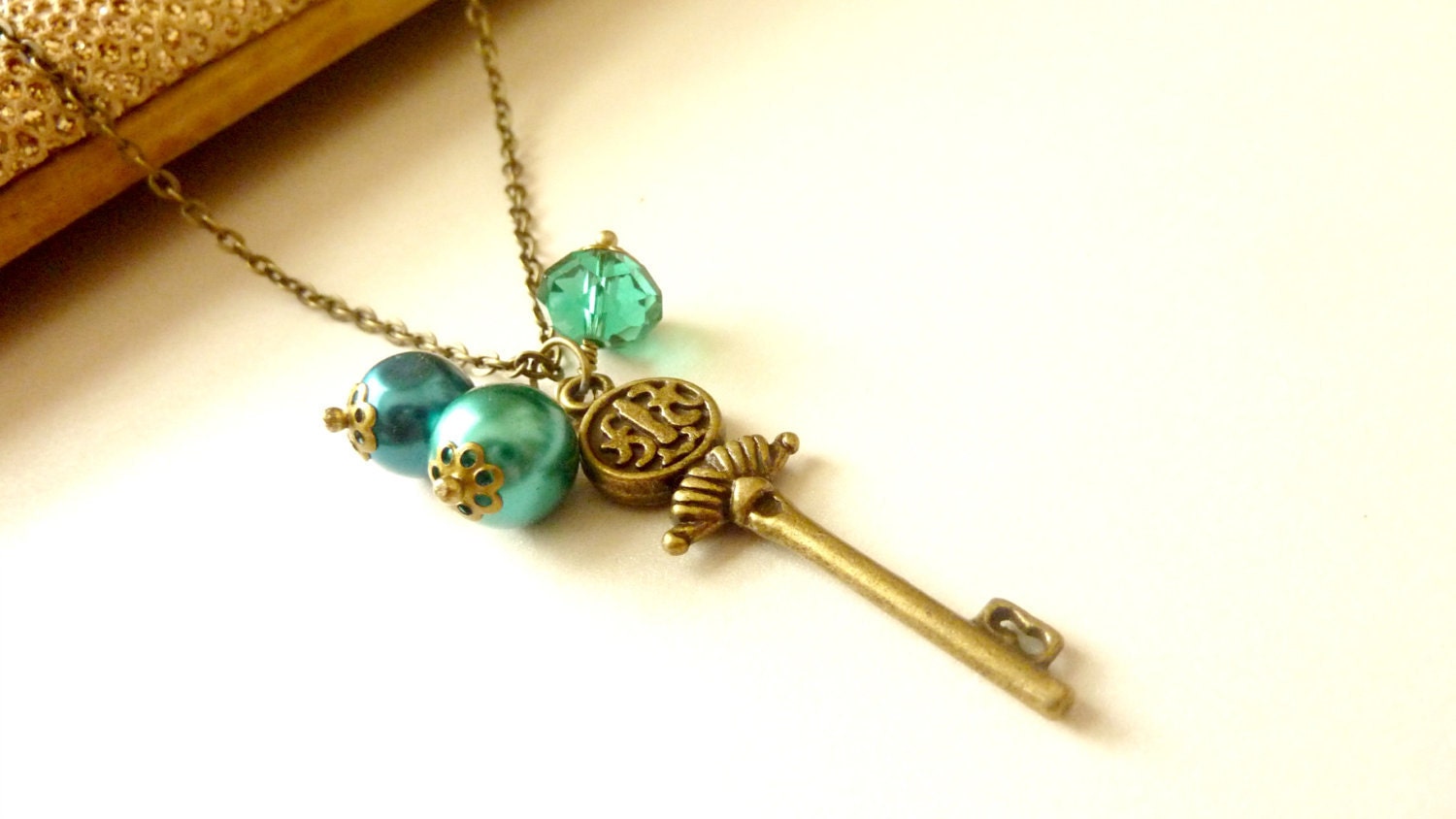 Vintage necklace brass charm scepter key chain with teal glass pearls and crystal beads
