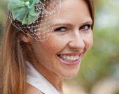 Wedding hair accessories, bridal headpiece, fascinator with a light green  flower made of silk organza an a pearl in the middle.