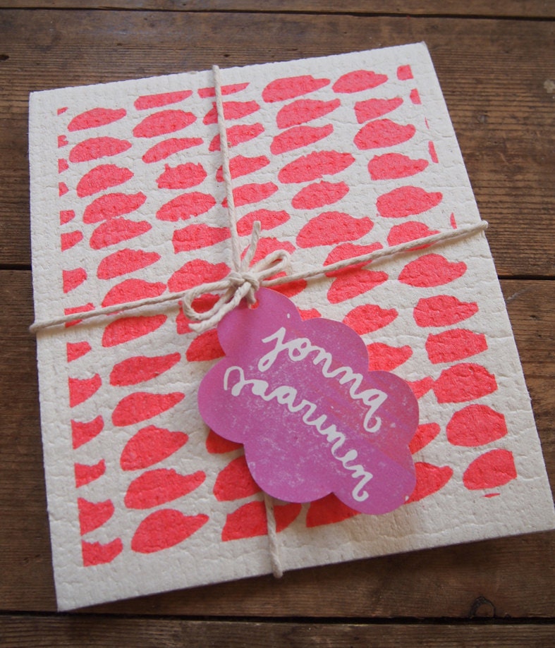 A pair of hand printed "Hundreds & Thousands" dishcloths in orange and pink - biodegradable