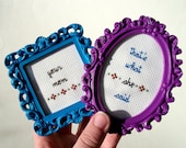 That's What She Said -- Your Mom mini set of funny framed cross stitches in purple oval frame and blue square frame