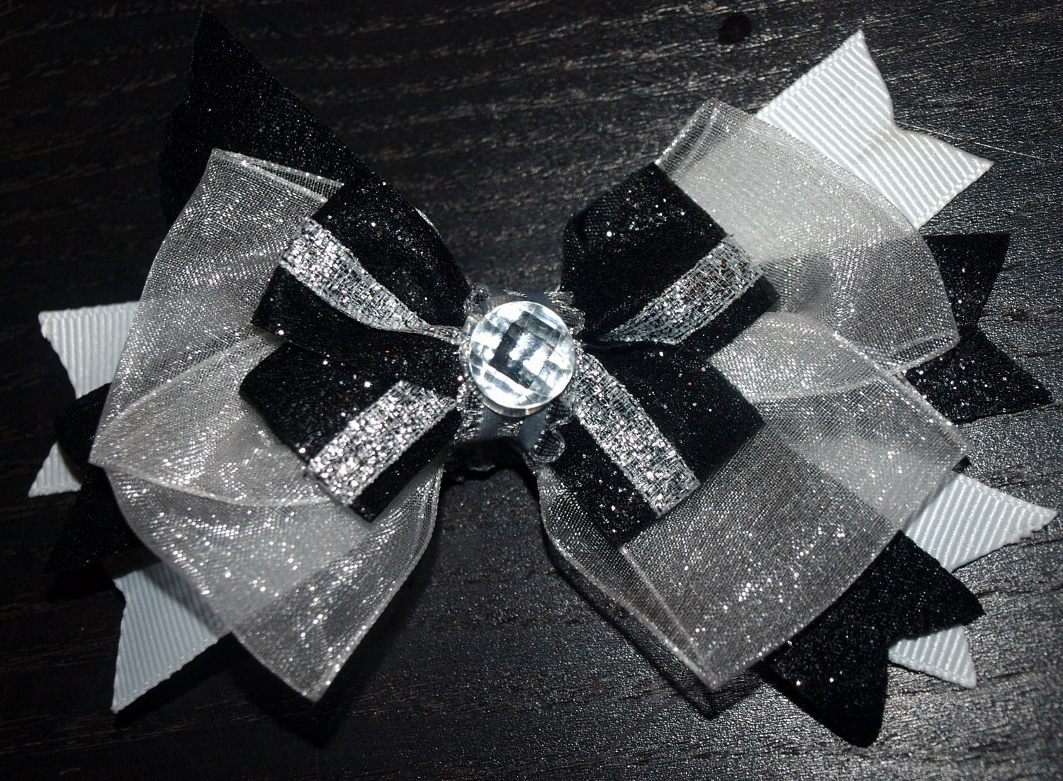 black, silver, and white bow