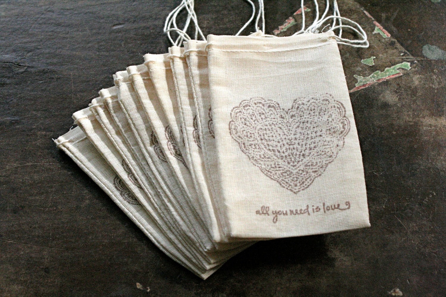 Wedding favor bags, muslin, 3x5. Set of 50. Lace heart and All You Need Is Love script in brown on natural white cotton.