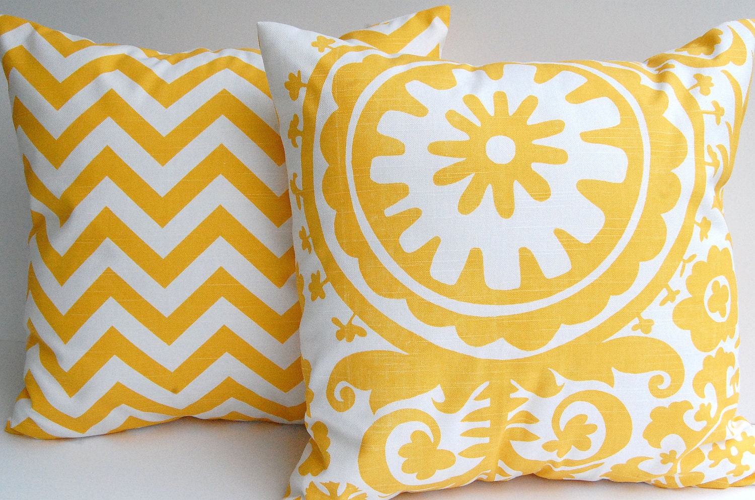 Yellow chevron throw pillow covers set of two 20" x 20" corn yellow and white zig zag chevron stripe and Suzani