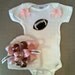 Pink football onesie set for baby girls with matching beanie hat with football boutique bow