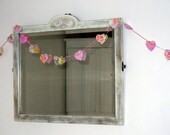 Scalloped heart garland from upcycled packaging.