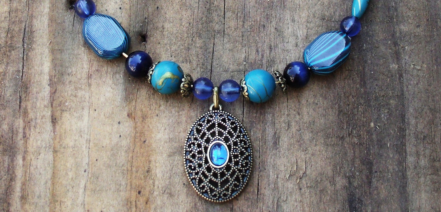Blue beaded neckace with pendant.