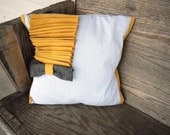 White, blue, mustard yellow and grey decorative pillow with grey bowtie