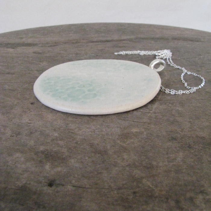 handmade ceramic necklace, full moon, lunar craters, pale turquoise