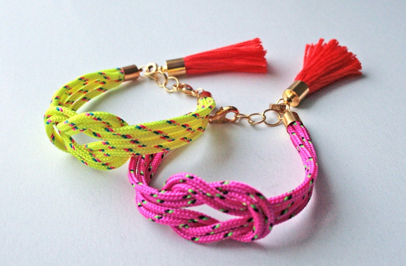 Neon pink knot rope bracelet with tassel charm