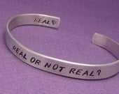 Hunger Games Inspired - Real Or Not Real - A Double Sided Hand Stamped Aluminum Bracelet