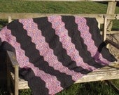 Ripple stitch afghan in jewel toned and charcoal grey yarn
