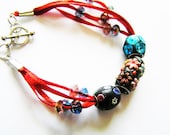 Unique Kashmiri Beaded Multiple Strand Bracelet on Red Ribbon with Crystal Bead Accents