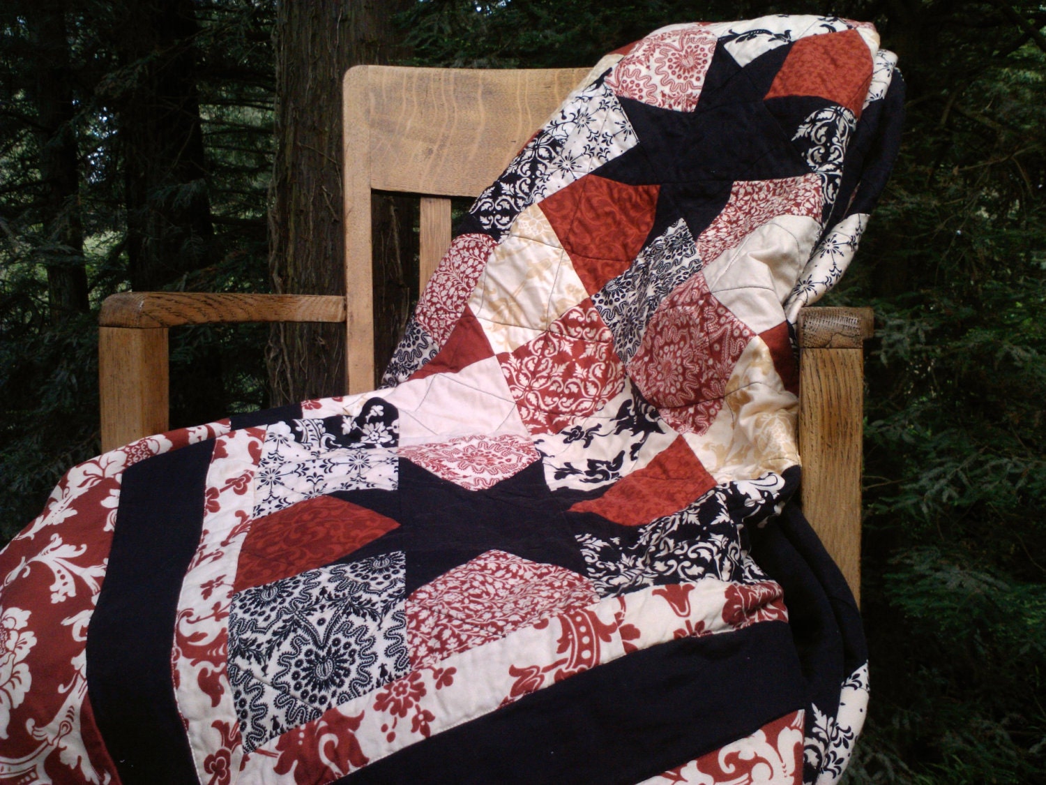 Queen size Sawtooth Star quilt in rich red, black, and creams.