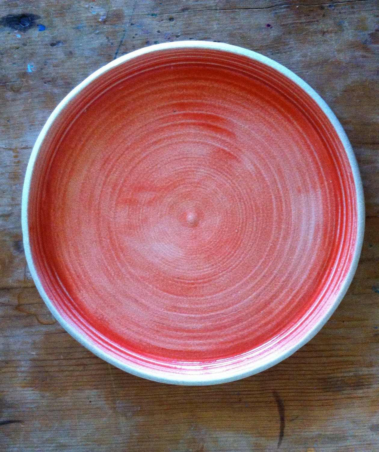 Handmade and painted ceramic pottery dinner ware plate. Red and white stoneware.