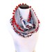 Infinity Circle Scarf with pom pom accents.