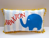 Baby pillow in baby blue stripes and bright blue elephant accent.  Personalized with poppy orange name.