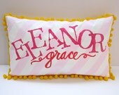 Baby pillow in light pink stripes with bright pink personalized name.