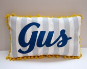 Baby pillow in light gray stripes and navy blue script. Personalized with name.