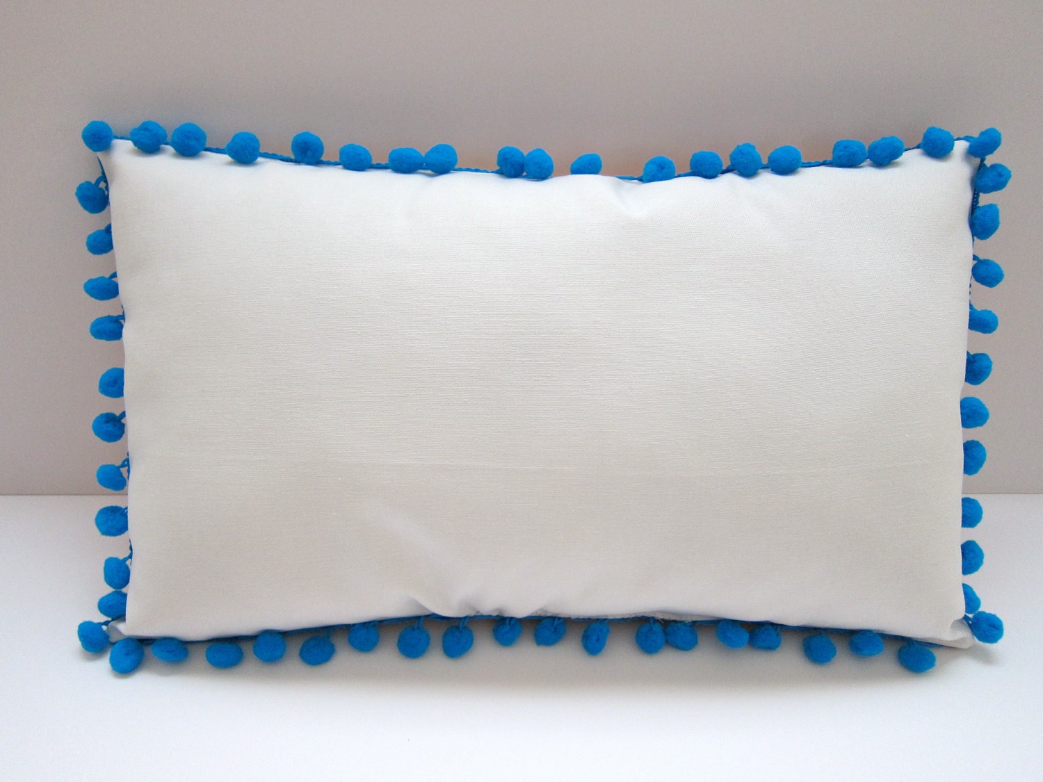 Baby pillow in orange and bright green. Personalized with name.