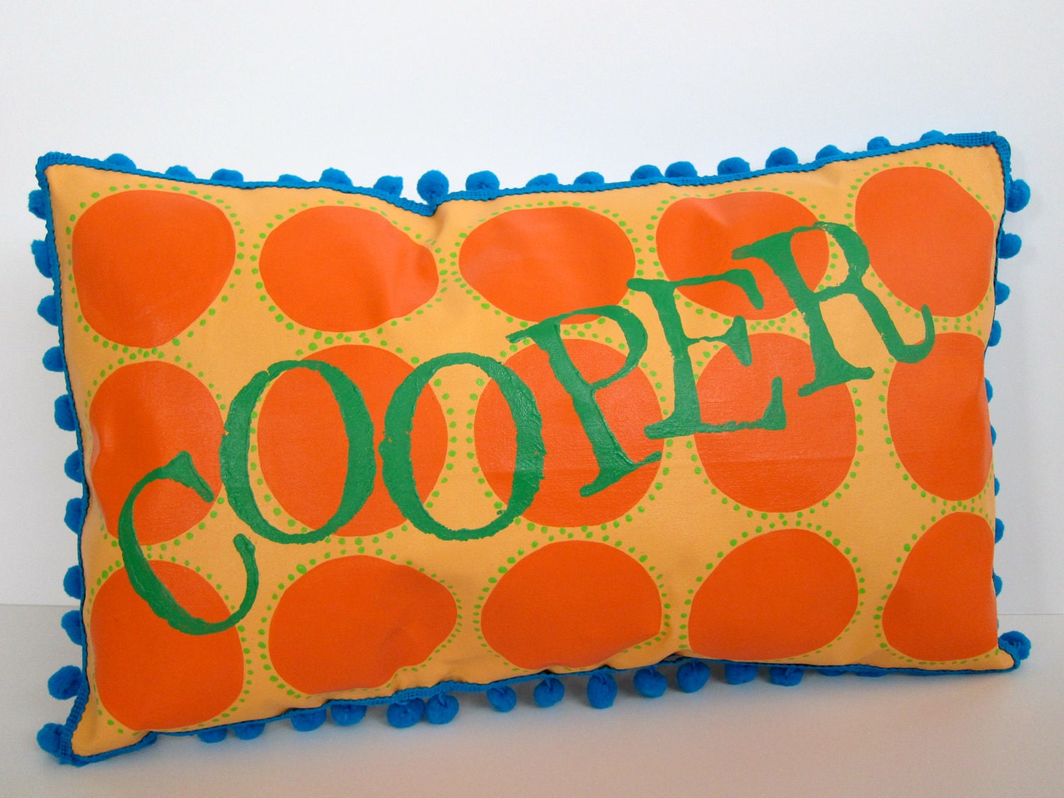 Baby pillow in orange and bright green. Personalized with name.