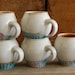 the perfect white and turquoise egg- shaped mug