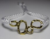White bracelet with bubbly goldish finding