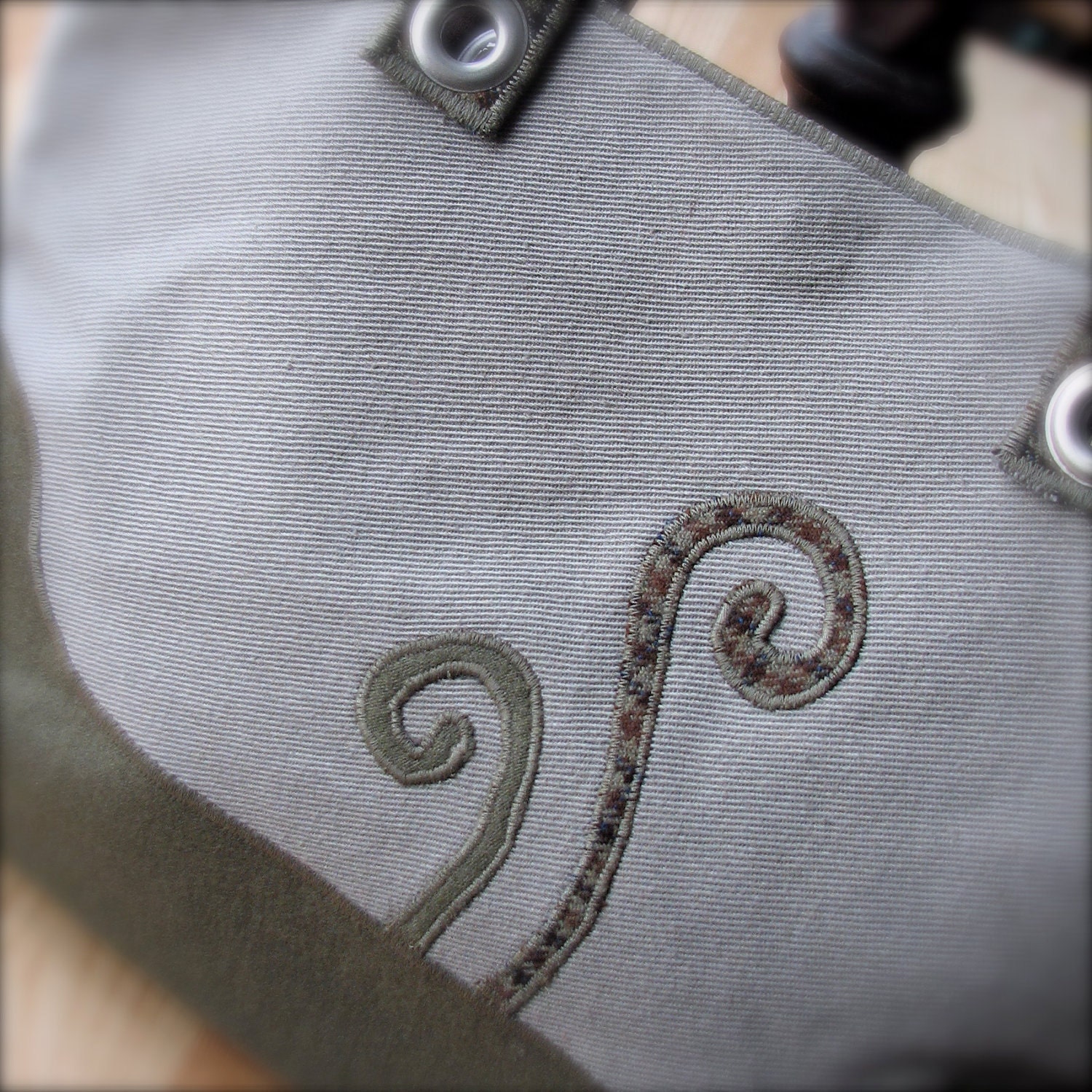 purse in earth tones with fiddlehead fern sprouts for spring