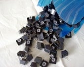 Keyboard pushpins are Black Modified keys from a computer keyboard are given a new life as pushpins.