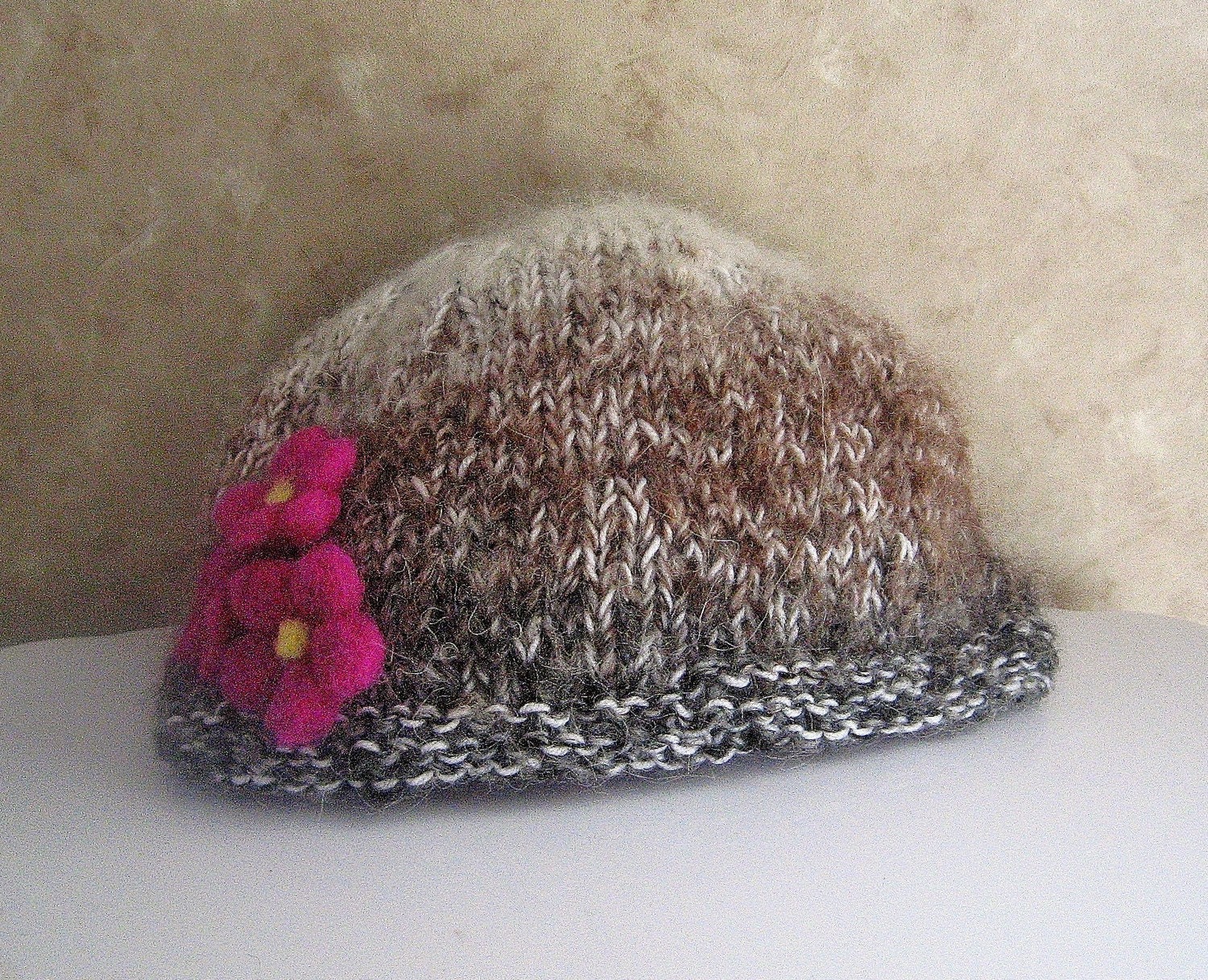Hand knit hat with fuschia needlefelted flowers