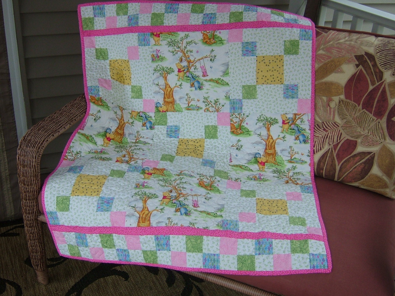 Crib Size Quilt featuring Winnie the Pooh in pink, yellow, white and bright green