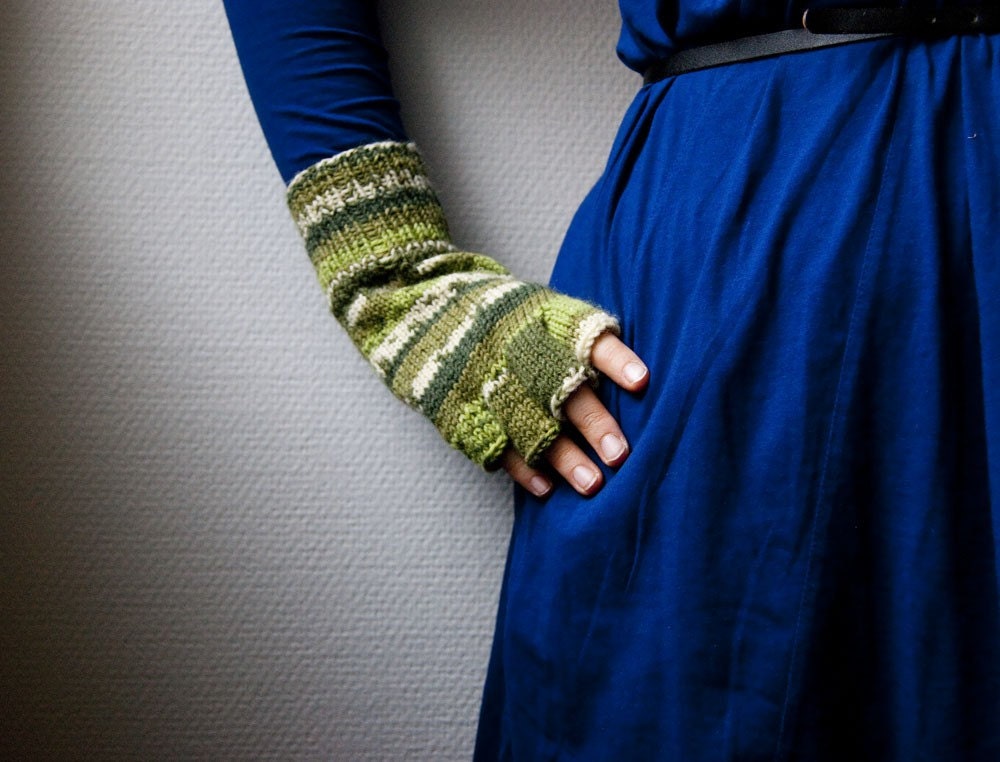 Warm fingerless gloves with stripes in hues of green and white. Hand knit in wool blend yarn.