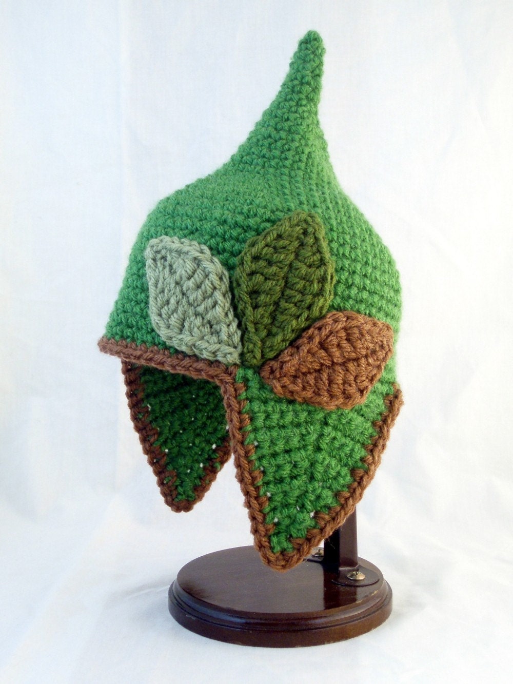 Pointed Green Baby Hat with Earflaps and Varying Green and Brown Leaves