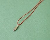 Silver hand on red silk cord