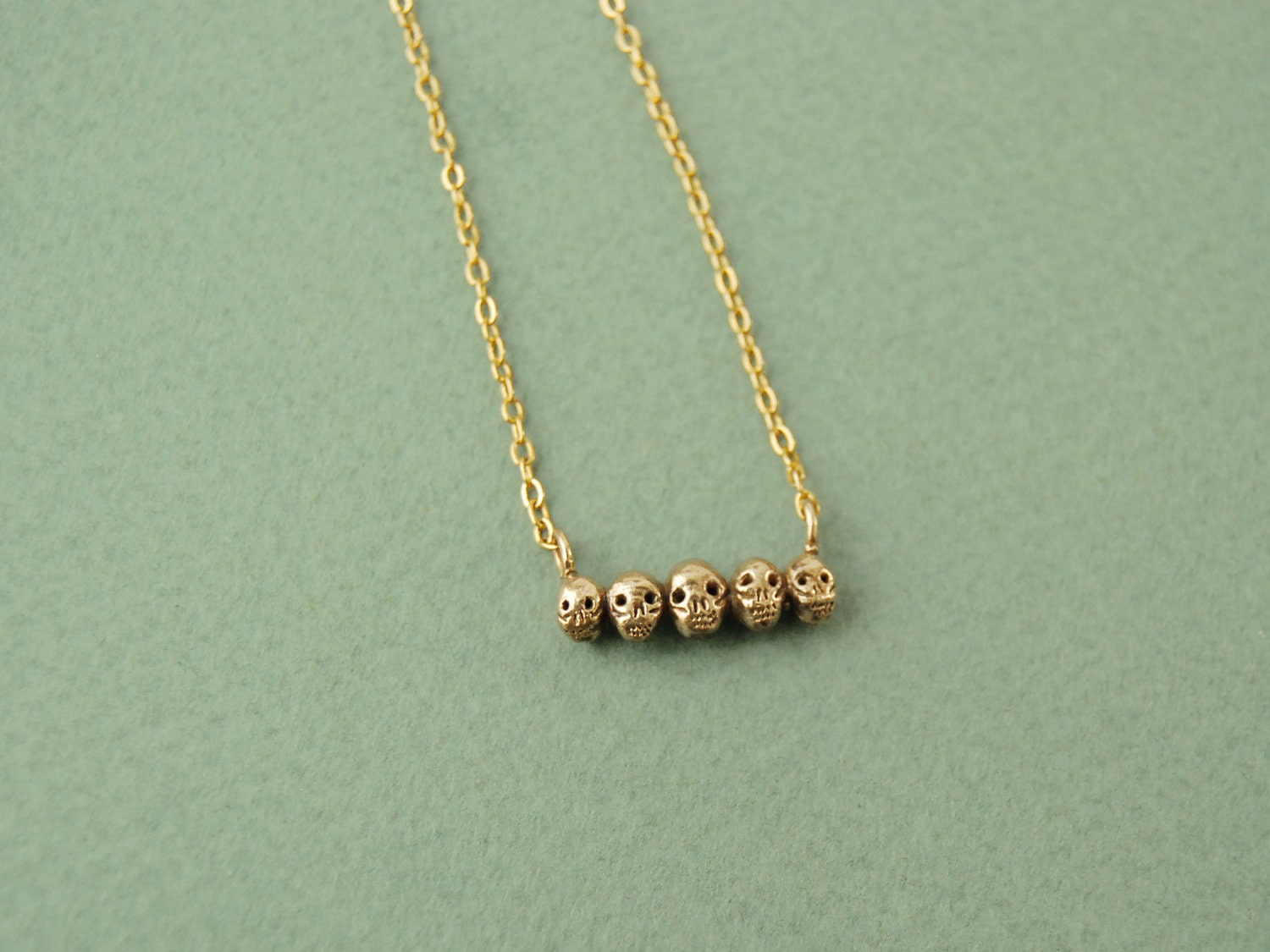 Tiny golden skull necklace