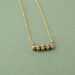 Tiny golden skull necklace
