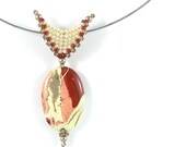 Oval gemstone pendant with beadwork bail