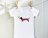 Dachshund baby clothes, chasing hearts. Long or short sleeve. Your choice of size.
