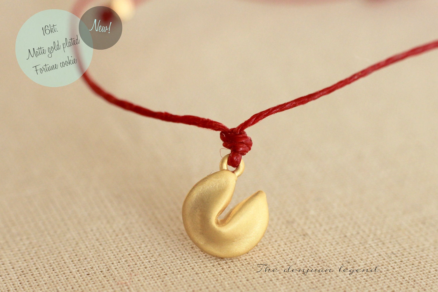 New - bracelet in 16kt. matte gold plated fortune cookie on waxed irish linen in dark red