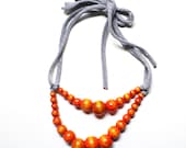 Color Pop Necklace in Orange & Grey . Non-toxic Beads with a Jersey Tie . Fashionable and baby-friendly