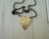 Handmade hammered  brass heart with oxidized sterling silver chain.