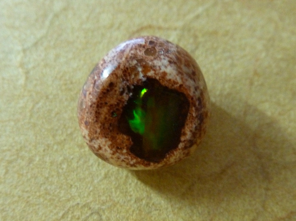 Fire Opal or Mexican Cantara Opal, a dainty delight wrapped in its pretty apricot colored matrix