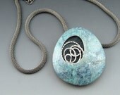 Modern simple blue polymer clay pendant with silver swirl on mesh chain